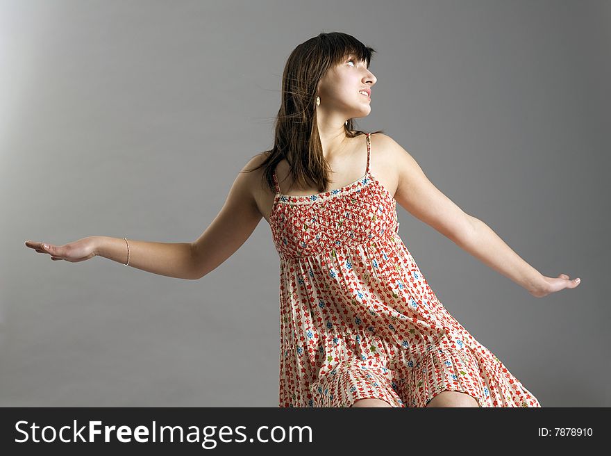 Teenager in dress on grey background. Teenager in dress on grey background