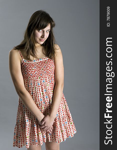 Teenager in dress on grey background. Teenager in dress on grey background