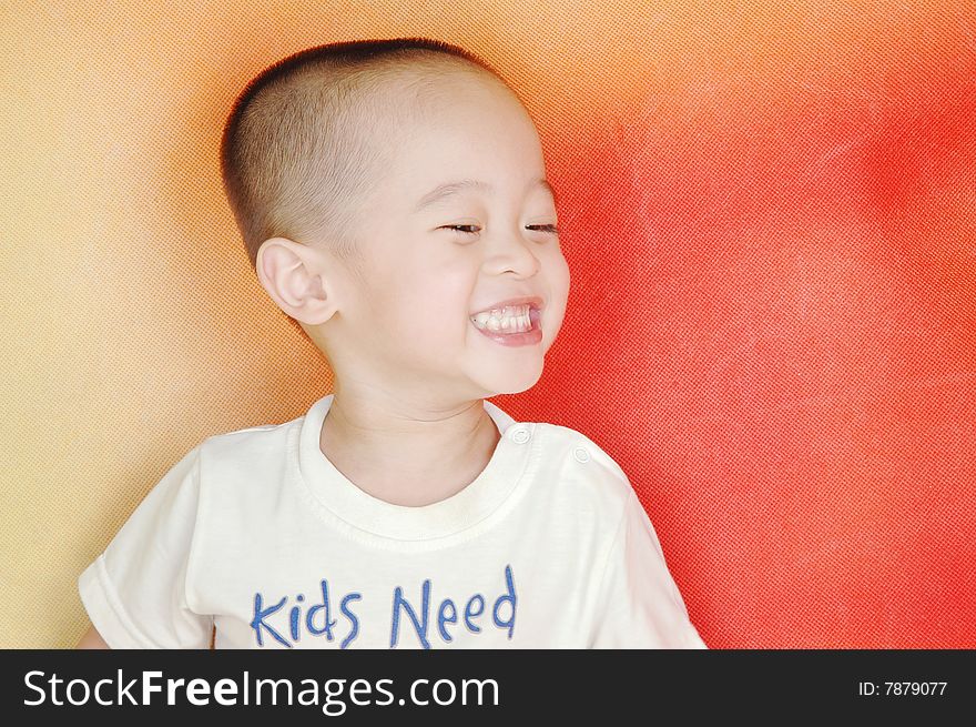 The boy the boy is laughing,his eyes like a line,white teeth exposed,he is very happy. The boy the boy is laughing,his eyes like a line,white teeth exposed,he is very happy.