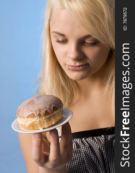 Teenager with the doughnut on the plate. Teenager with the doughnut on the plate