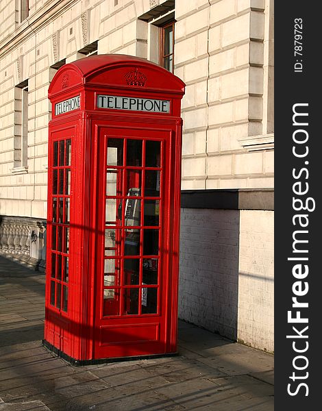 Red telephone kiosk on London street. Red telephone kiosk on London street