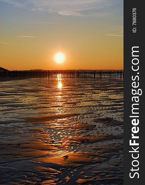 Wet empty beach with last sun over it. Wet empty beach with last sun over it