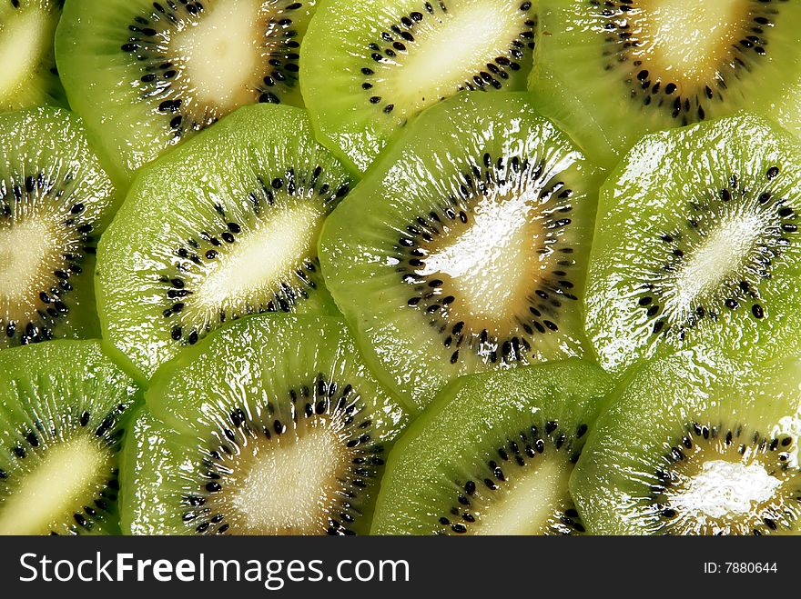 Beautiful green texture consisting of slices of kiwifruit on a white background