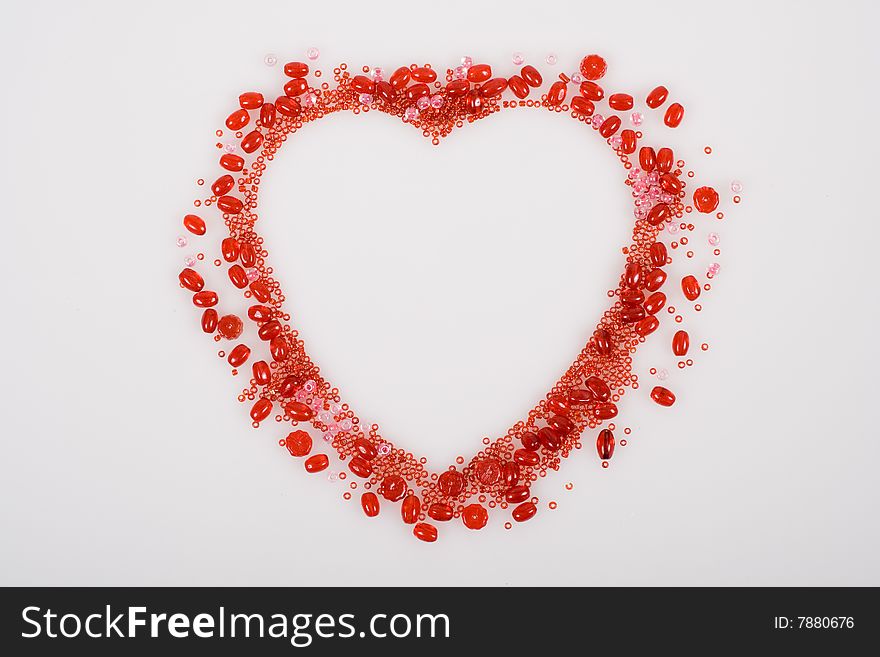 Red heart made with beans isolated on white background