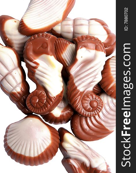 The image of sweet chocolate candies in the form of marine shellfish isolated on a white background