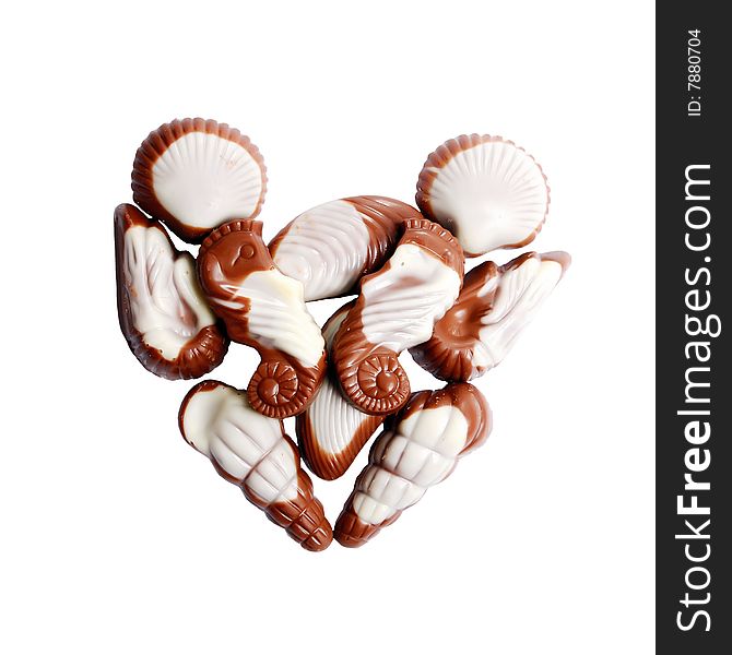 The image of sweet chocolate candies in the form of marine shellfish isolated on a white background