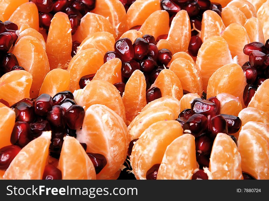 Beautiful still life of tangerine stuffed with pomegranate seeds