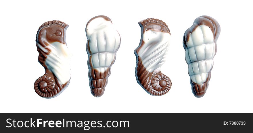 The image of sweet chocolate candies in the form of marine shellfish isolated on a white background