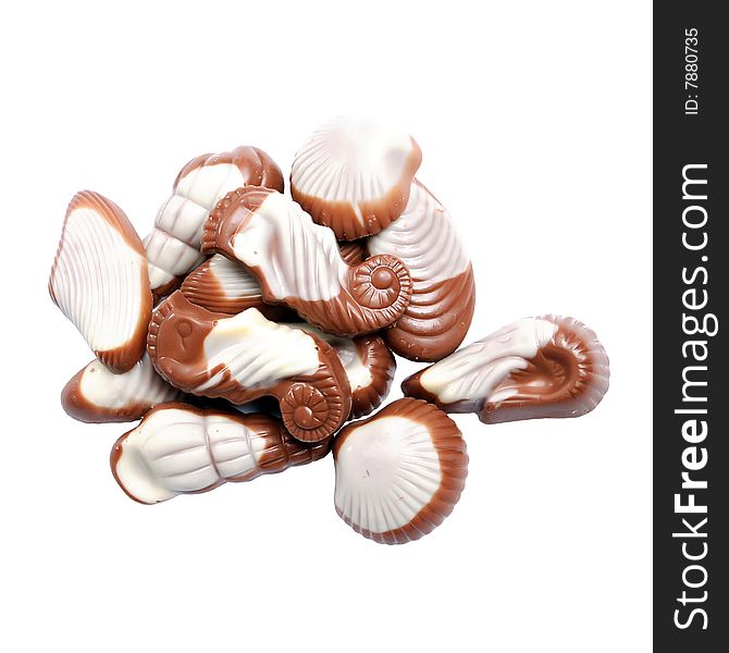 The image of sweet chocolate candies in the form of marine shellfish isolated on a white background