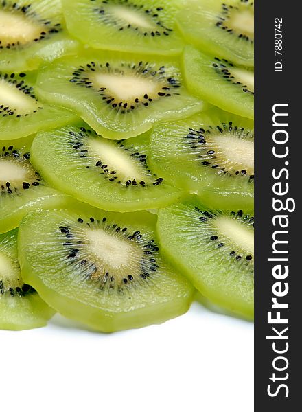 Beautiful green texture consisting of slices of kiwifruit on a white background