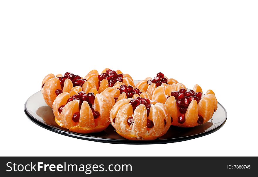 Beautiful still life of tangerine stuffed with pomegranate seeds