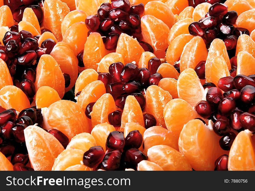 Beautiful still life of tangerine stuffed with pomegranate seeds