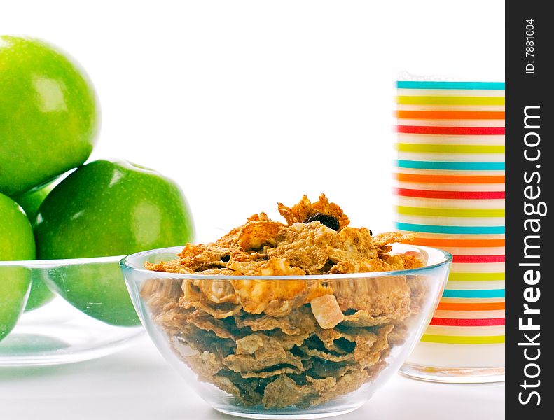 Cornflakes, glass of milk and green apples