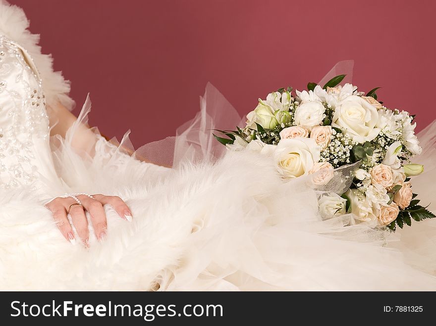 Wedding bouquet on a background of dress of the bride