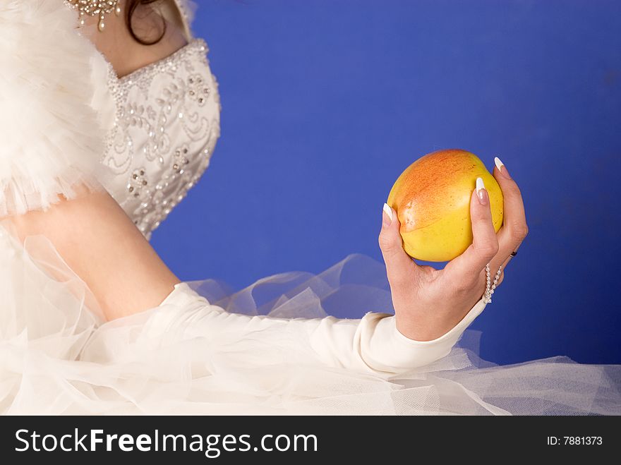 The bride with an apple on a dark blue background