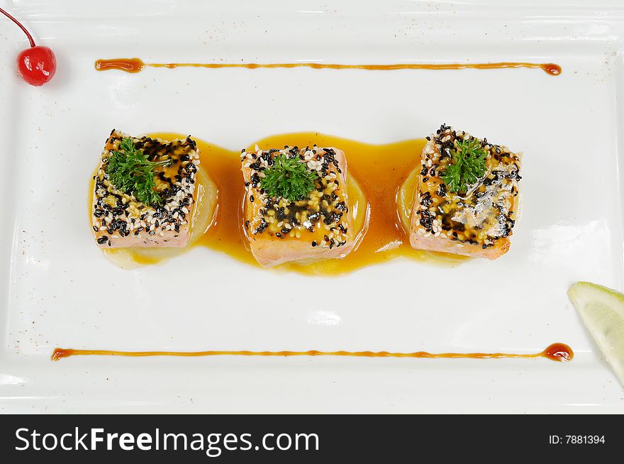 A fish restaurant row on white dish. A fish restaurant row on white dish