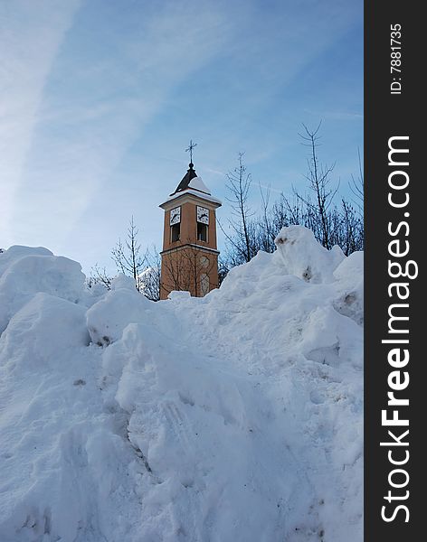 Belfry and clock in winter landscape with tons of snow. Belfry and clock in winter landscape with tons of snow