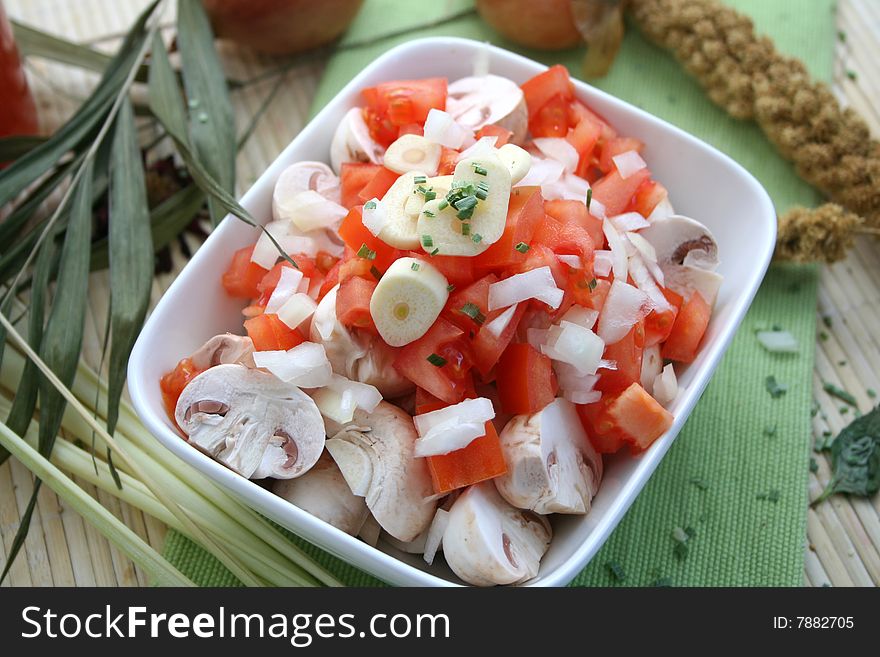 Fresh vegetables like mushrooms and tomatoes with garlic and onions