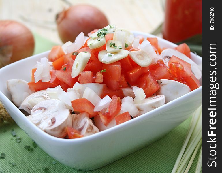 Fresh vegetables like mushrooms and tomatoes with garlic and onions