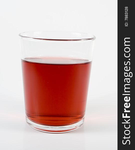 Juice cherry in transparent glass on white