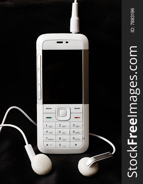 White mobile phone on black background