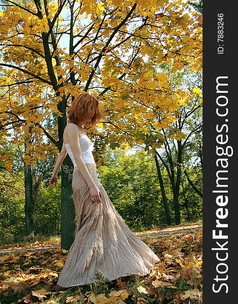 Young Woman In An Autumn Park