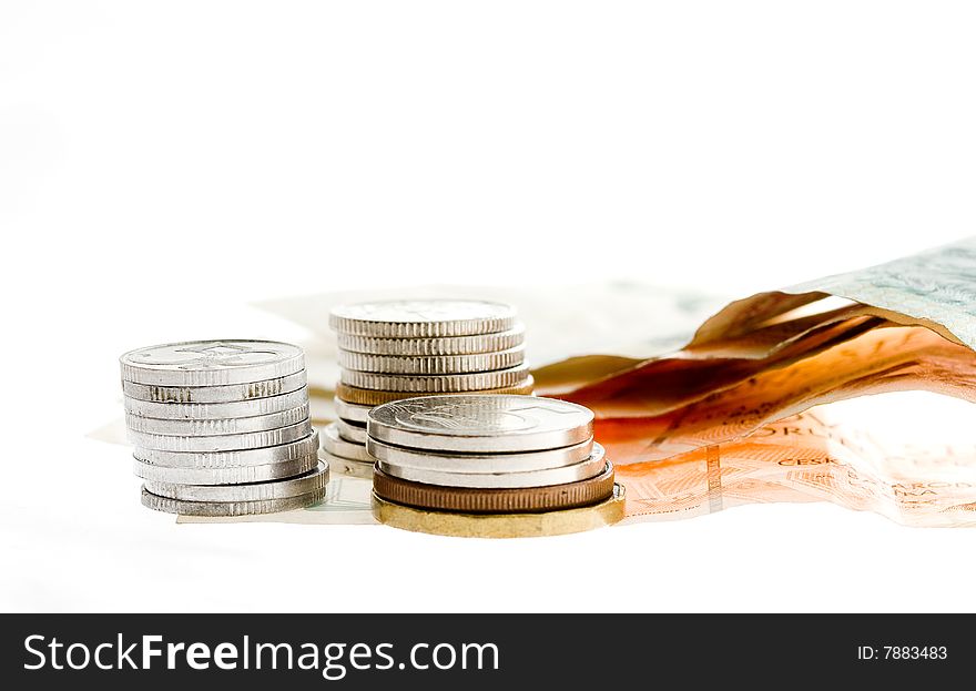 Czech bank notes and coins on white background