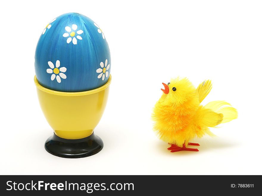 Easter chick and easter blue egg with white flower on white background.