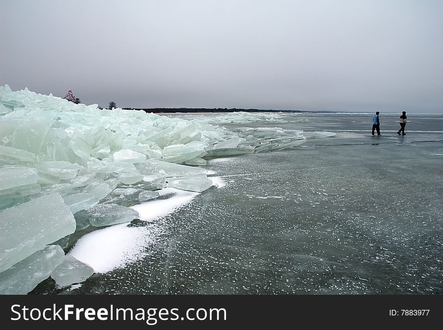 Iceberg with walking people in Peipsi lake in Estonia