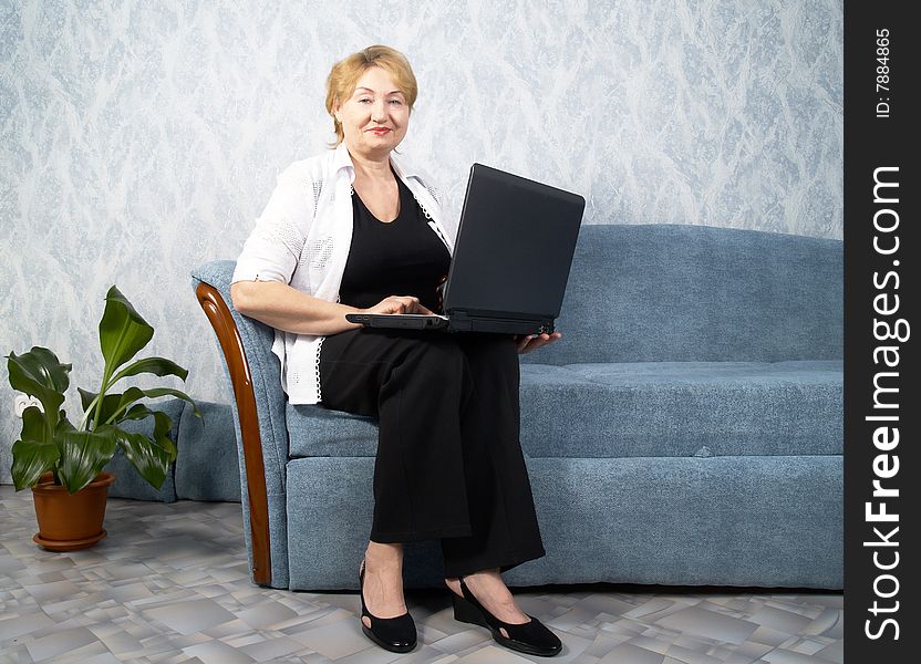 The business mature woman with a laptop. The business mature woman with a laptop