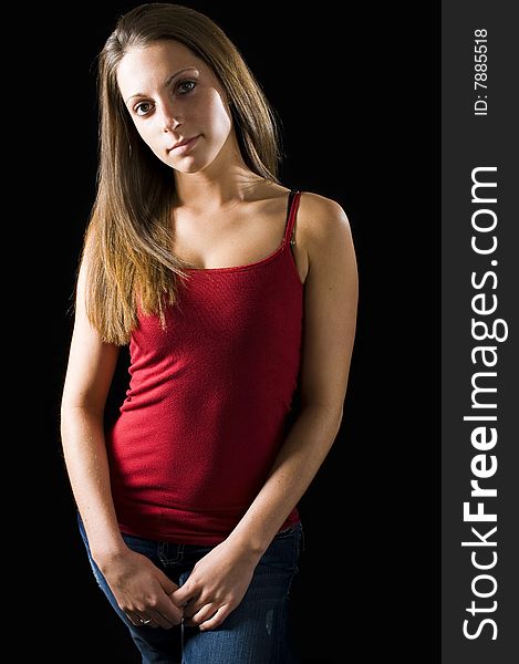 Cute model wearing a tight red tank top and jeans. Cute model wearing a tight red tank top and jeans.