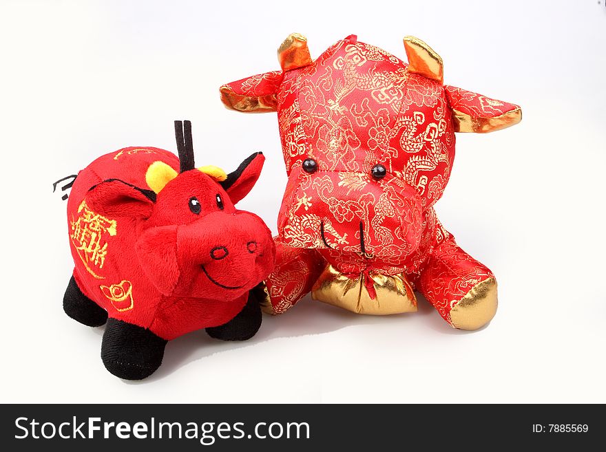 Two Chinese lucky oxen are on white background.So cute.

Chinese characters on the lucky ox has are getting rich.