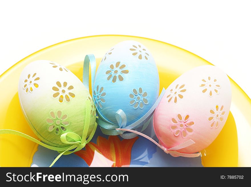 Easter eggs on yellow plate.