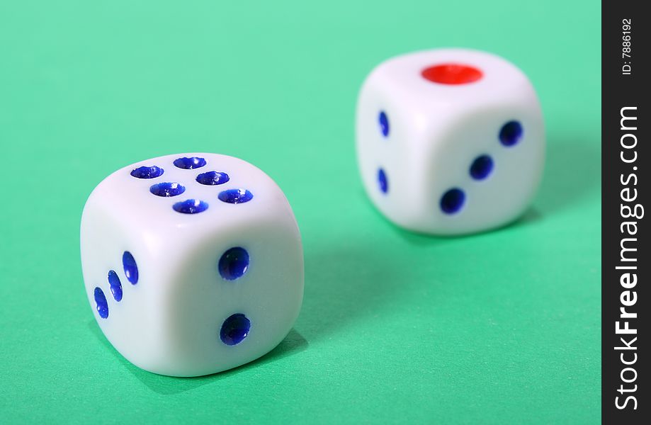 Some playing bones from above on a green background. Some playing bones from above on a green background