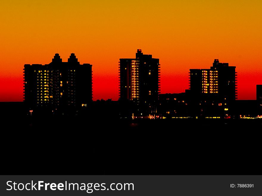 Silhouettes of highrises with orange sky on the bayside in Florida. Silhouettes of highrises with orange sky on the bayside in Florida