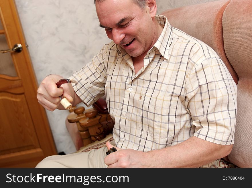 The man opens bottle of a champagne. The man opens bottle of a champagne