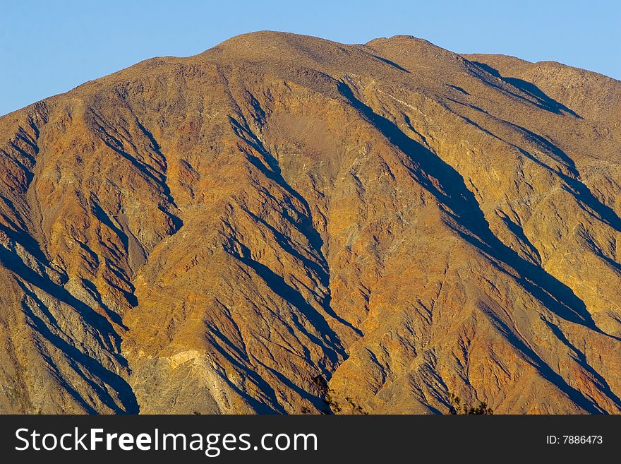 A rust colored hill in the Southern California desert. A rust colored hill in the Southern California desert