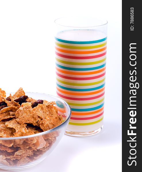 Bowl with cornflakes and glass of milk