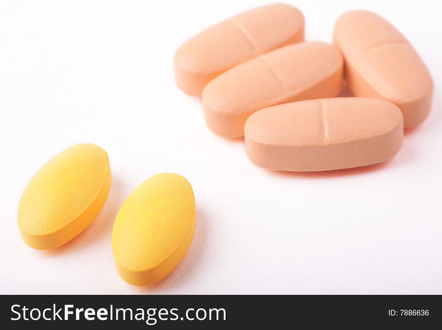 Cloroful Pills Lying On White Background