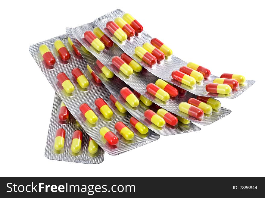 Red and yellow paks of pills isolated on white background