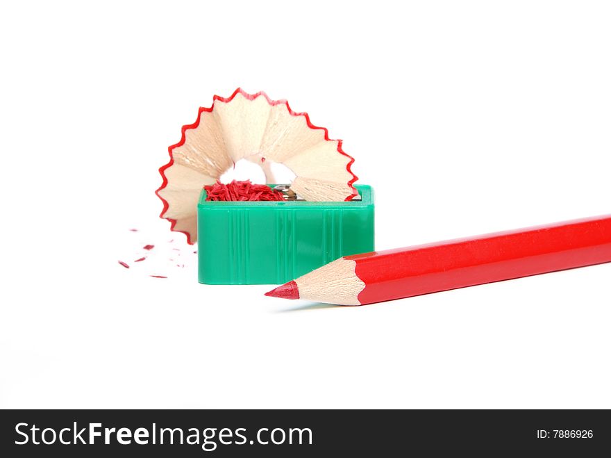 Red pencil and green sharpener on a white background. Red pencil and green sharpener on a white background