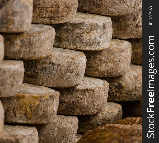 Stack of cheese wheels on a market in southern france. Stack of cheese wheels on a market in southern france