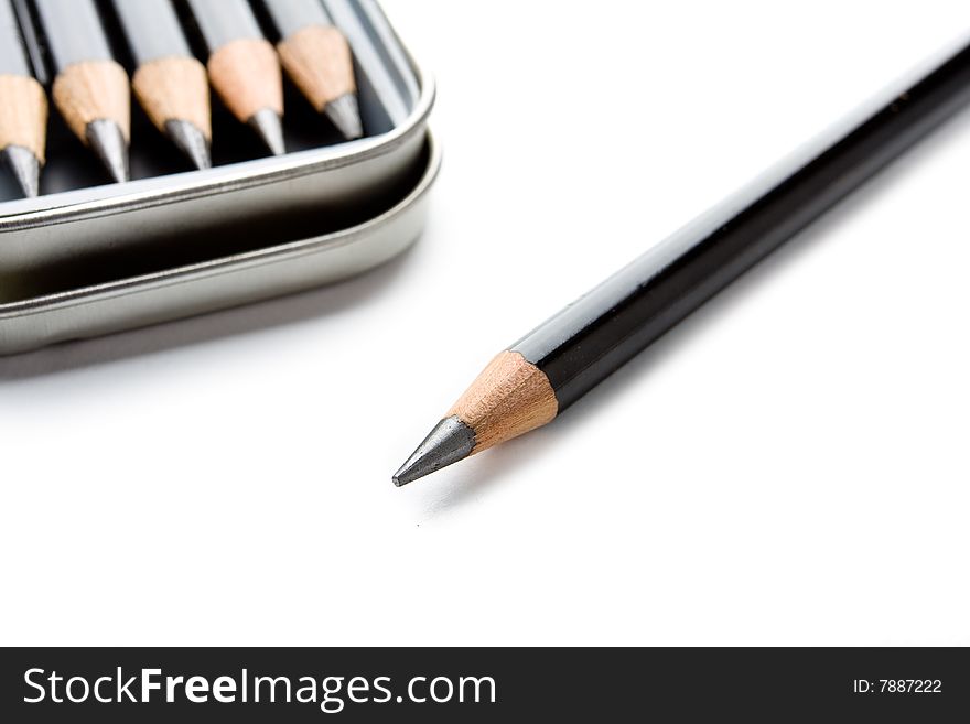 Several pencils in a tin isolated on a white background