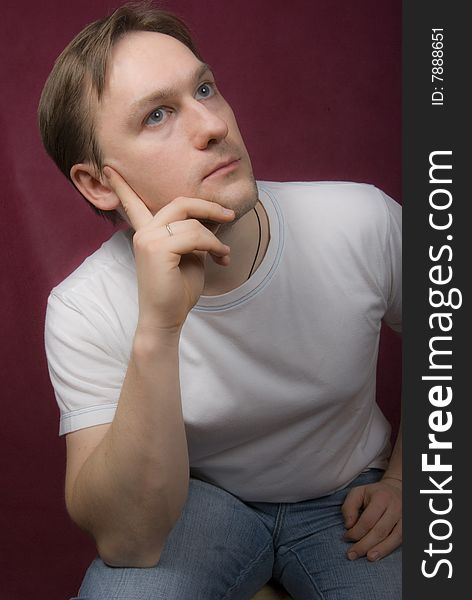 Portrait of a young man on the purple background. Portrait of a young man on the purple background