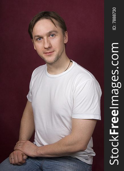 Portrait of a young man on the purple background. Portrait of a young man on the purple background