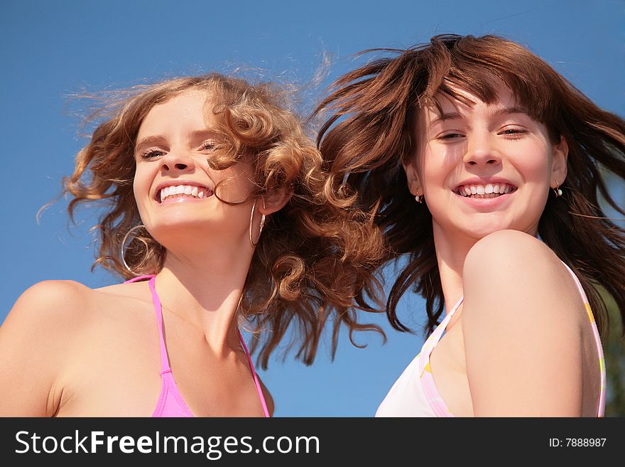 Two girlfriend with windy hairs