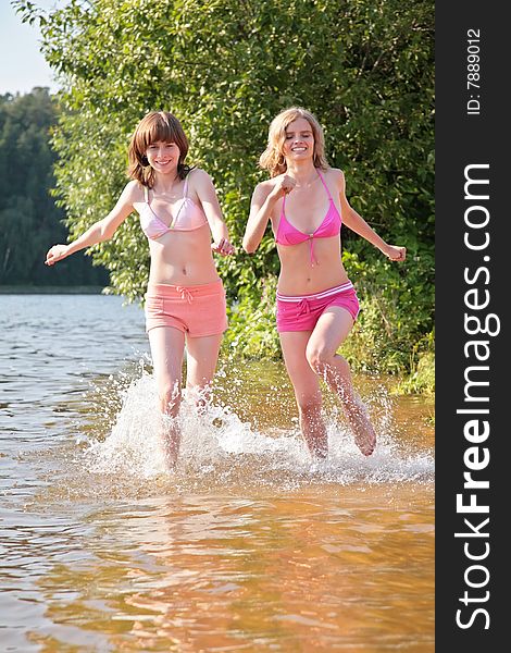 Two girl runs on water, summer