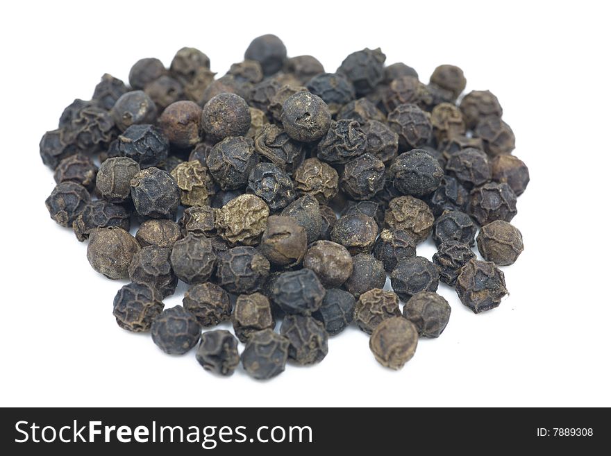 Macro shot of a pile of peppercorns isolated on white