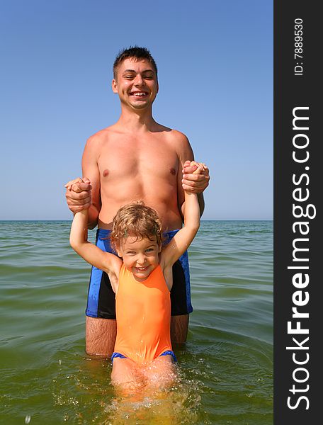Father with child in sea