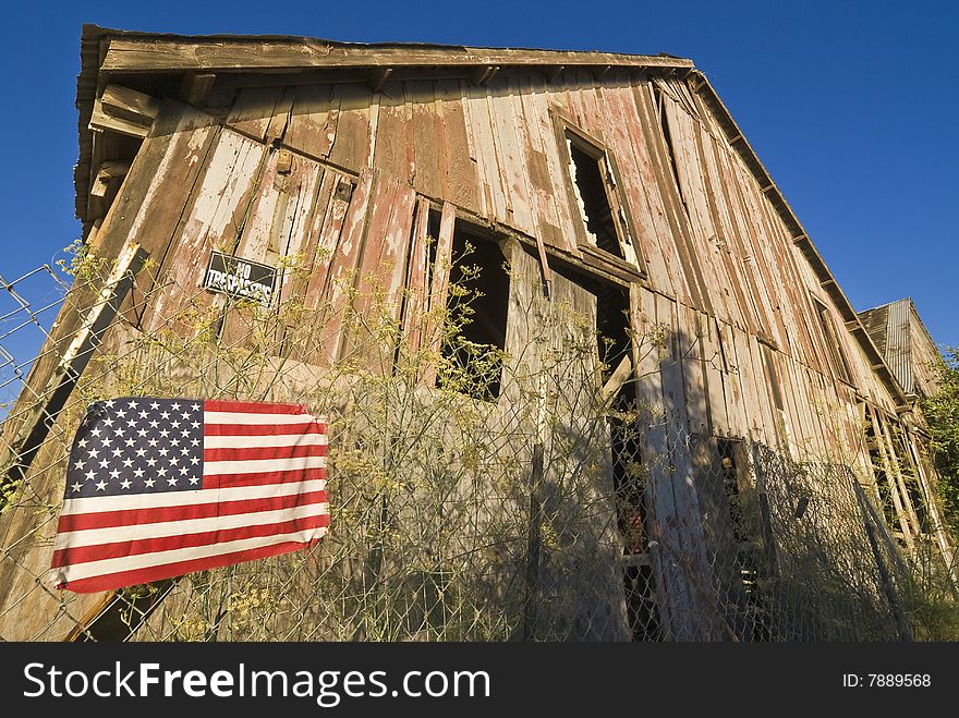 American Flag And Decrepit Building